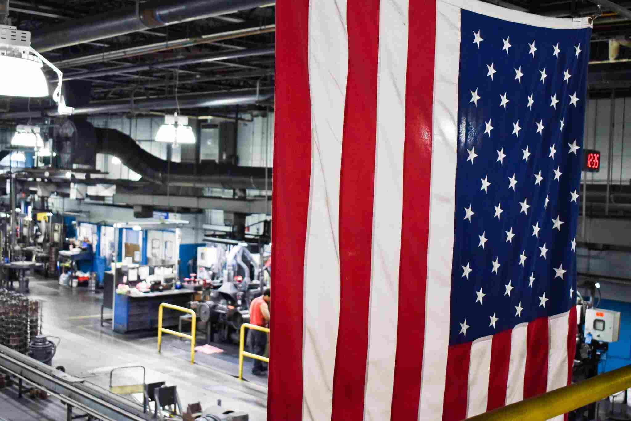 American flag hanging above factory floor